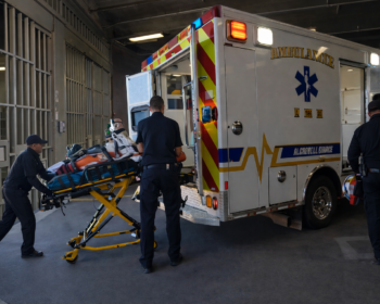 Emergency medical personnel transporting a detainee from a jail facility to an ambulance